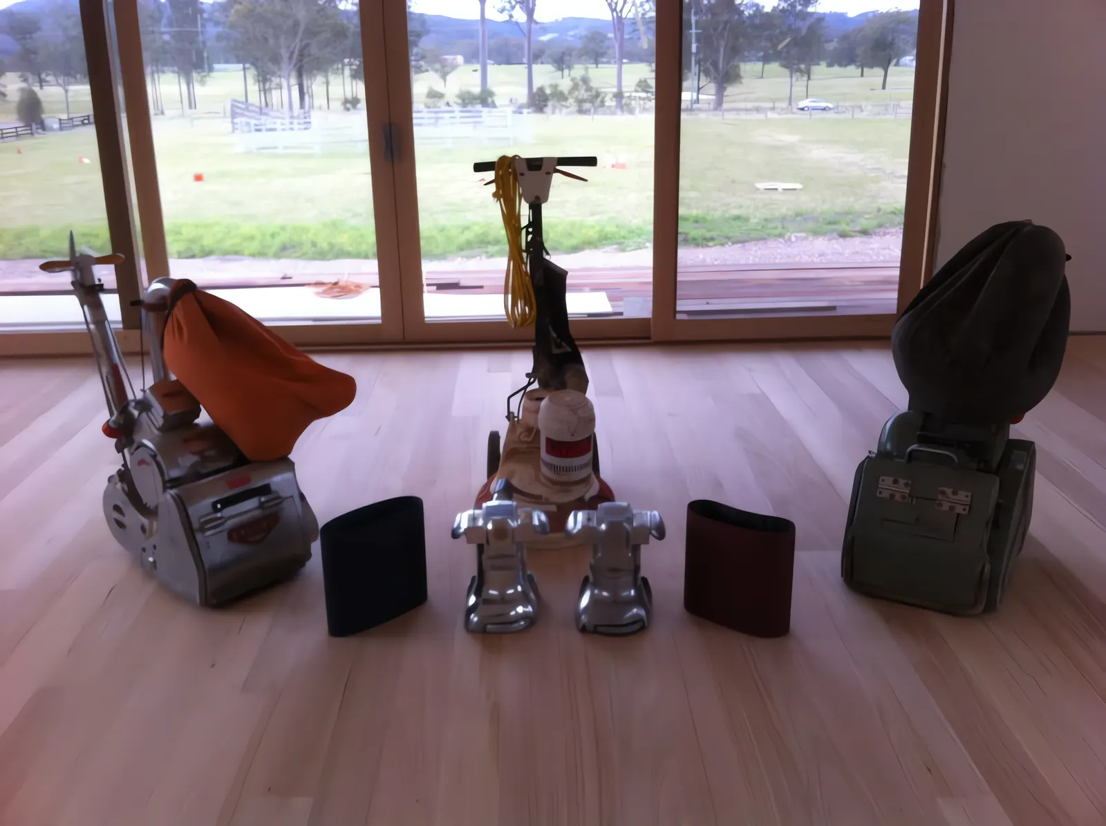 A & T’s floor sanding machines lined up on a finished floor
