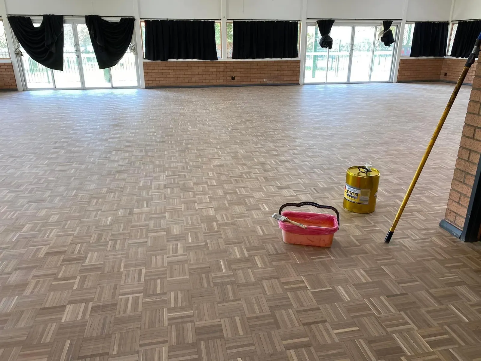 Parquetry hall floor before sanding, dull and stained