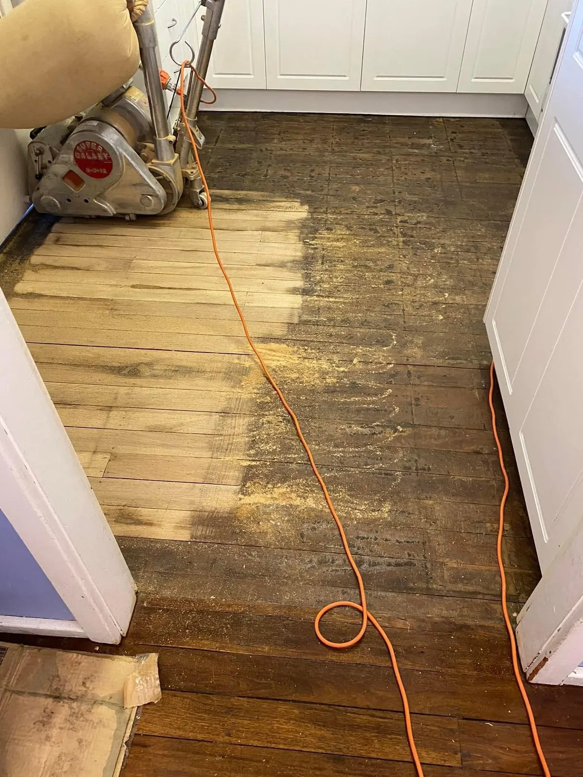 Drum sander mid job on a timber floor